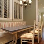 After picture of a custom designed kitchen table that we designed for our client. We also reupholstered the banquette seat and chairs.