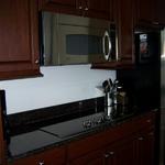 Before picture of a kitchen prior to designing and installing the glass back splash