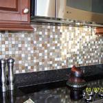 After picture of the kitchen with newly installed glass tile back splash